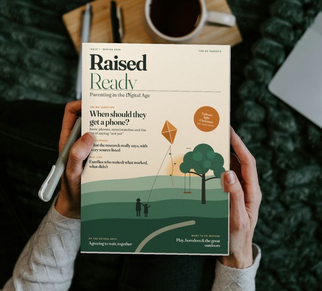 Hands holding a copy of Raised Ready, Issue 1